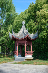 A traditional architectural pavilion in the woods of a Chinese urban park.