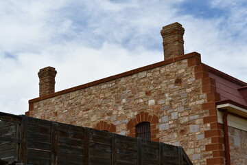 Old stone prison against clear blue sky.