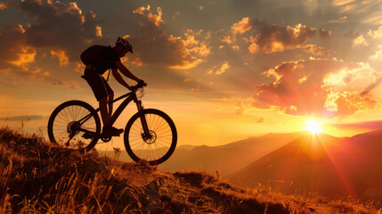 Obraz premium Cyclist rides mountain bike against stunning sunset backdrop, with rays of sunlight breaking through clouds. scene captures thrill of adventure and beauty of nature