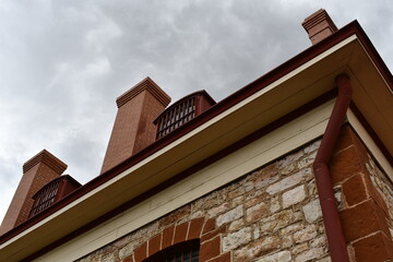 Menacing old stone building against gray sky.