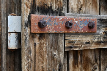 Large iron bracket on old wooden fort gate.