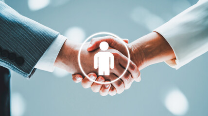 A professional business handshake photograph with a glowing digital user icon overlay.