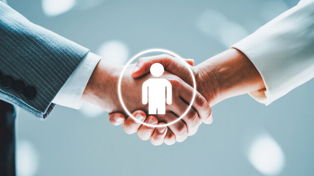A professional business handshake photograph with a glowing digital user icon overlay.