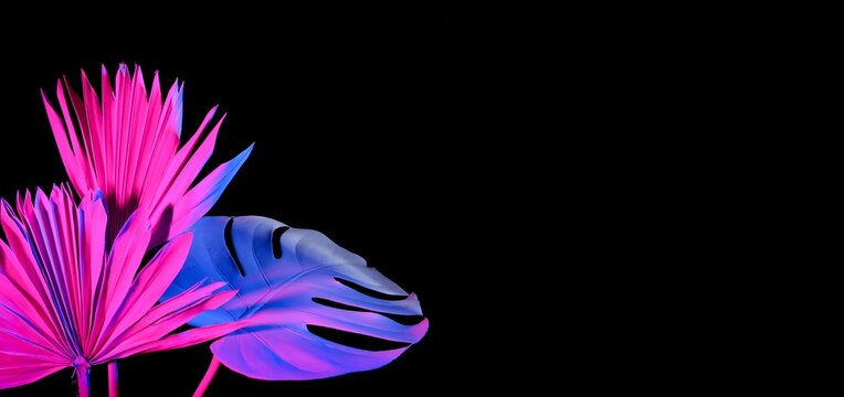Neon tropical leaves on black background with space for text - Powered by Adobe