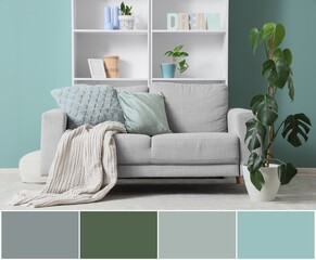 Interior of living room with comfortable sofa and shelving unit near mint wall. Different color patterns