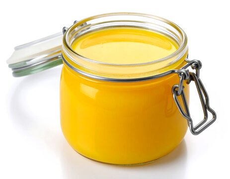 A glass jar of golden yellow clarified butter, slightly angled, lid ajar, on a white background