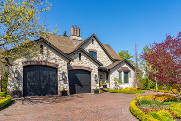 Two story stucco luxury house with nice spring blossom landscape in Vancouver, Canada, North America. Day time on May 2025.