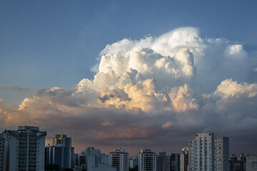 dramatic sky with orange tones in a sunset with buildings in sao paulo with dramatic clouds in the sky