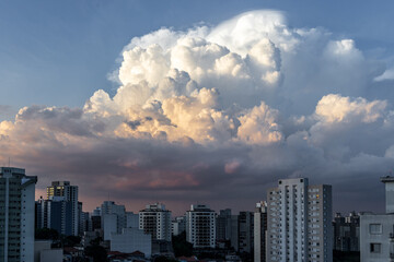 dramatic sky with orange tones in a sunset with buildings in sao paulo with dramatic clouds in the sky