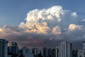 dramatic sky with orange tones in a sunset with buildings in sao paulo with dramatic clouds in the sky