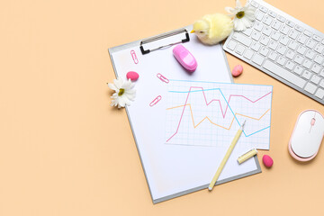 Business diagrams with stationery, computer keyboard, chicken, flowers and Easter eggs on beige background