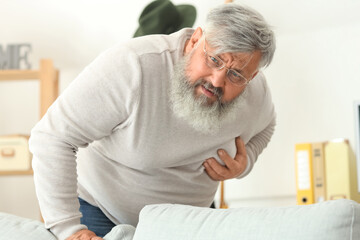 Elderly man having heart attack at home