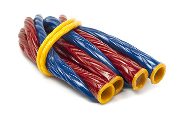 Bundle of twisted red and blue licorice sticks tied with yellow band
