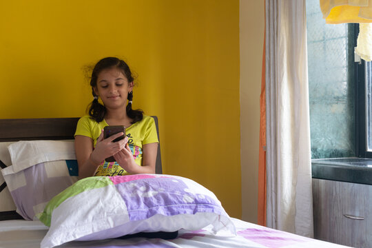 Girl watching mobile phone. Technology, addiction, knowledge, screentime, parents, children, young autism digital wellbeing future indian content online fraud gaming reels video chatting mental health