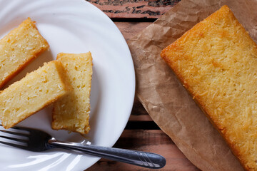 Traditional homemade cassava cake whit coconut on a rustic wooden table