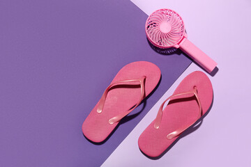 Flip flops with portable electric fan on color background