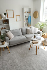 Obraz premium Comfortable sofa with cushions in interior of living room