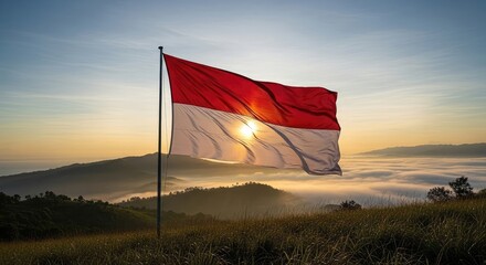 Flag waving over misty hills at sunrise