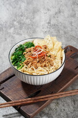 bowl of chicken noodle with chopstick