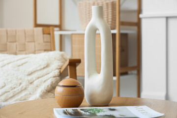 Coffee table with decor and magazine in interior of living room. Closeup