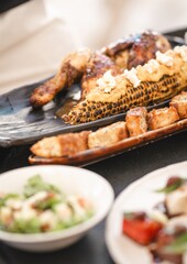 close-up Caribbean fusion BBQ corn and grilled chicken – tropical luxury beach restaurant cuisine