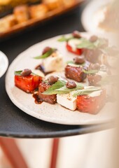 italian inspired dish with olives feta basil and watermelon aesthetic lifestyle food plate | vertical photo