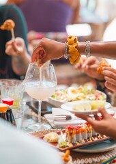 woman squeezing lime into cocktail with sushi plate – Caribbean tropical beach restaurant lifestyle