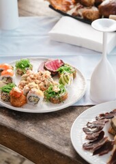 luxury sushi platter photo in caribbean beach club restaurant with blurred dishes in background and champagne glass