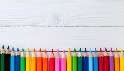 A vibrant row of colored pencils on a white wooden background, symbolizing creativity, art, and education.