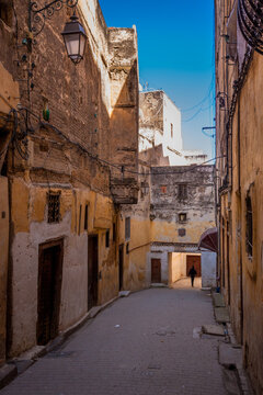 Silhouetted Man Walks through a Medina Alleyway in Fes Morocco