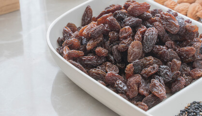 Portion of raisins in a container on the table