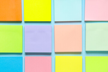 Many colorful sticky notes on blue background