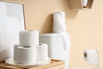 Rolls of toilet paper on basket in stylish restroom, closeup