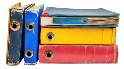 old binders in blue yellow and red hues stacked neatly on white background