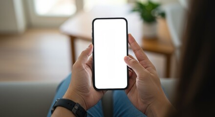 Close up of hands gripping mobile phone with blank display and wristwatch on left wrist