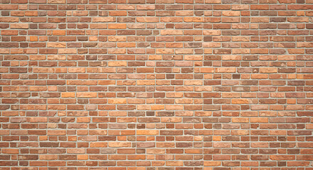 Naklejka premium A detailed close up of an aged weathered brick wall with a warm earthy tone and visible mortar lines creating a textured background