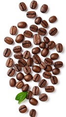 Obraz premium Roasted coffee beans scattered on white background, a single green leaf rests near the bottom