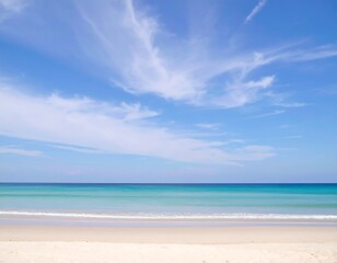 Obraz premium Soft-focus seascape; tranquil ocean meeting pale sand under a vibrant blue sky scattered with wispy clouds
