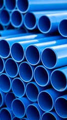 Stacked, bright blue cylindrical pipes create a repeating pattern