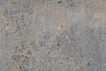 Textured background of old rough concrete wall with broken and crumbling patches
