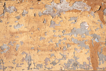 Heavily worn and neglected concrete wall with visible chips and holes throughout