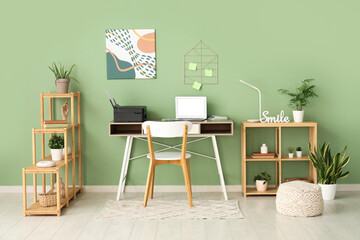 Workplace with modern printer and laptop in stylish home office