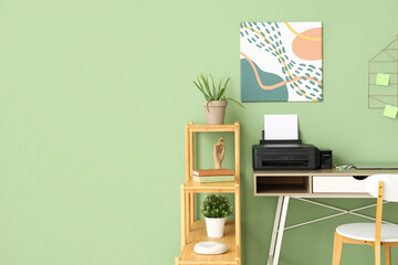 Workplace with modern printer and laptop in stylish home office