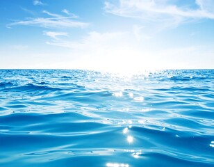 Sunlit ocean surface with gentle waves and a clear blue sky