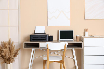Workplace with modern printer and laptop in stylish home office