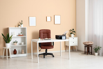 Workplace with modern printer, laptop and comfortable chair in stylish home office