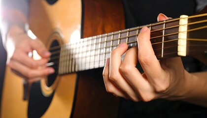 Obraz premium Close-up of skilled hands strumming an acoustic guitar, capturing the essence of musical creation and passion.