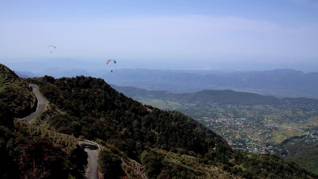 Mountain road view from paragliding in bir billing.
This breathtaking aerial video captures the winding mountain road of Bir Billing, Kangra, Himachal Pradesh, as seen from a paragliding flight.