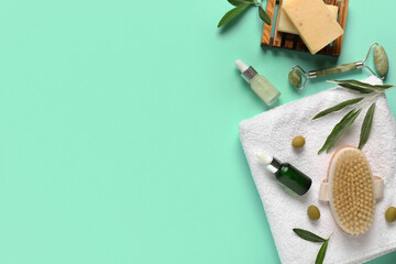 Composition with cosmetic products, spa accessories and green olives on color background
