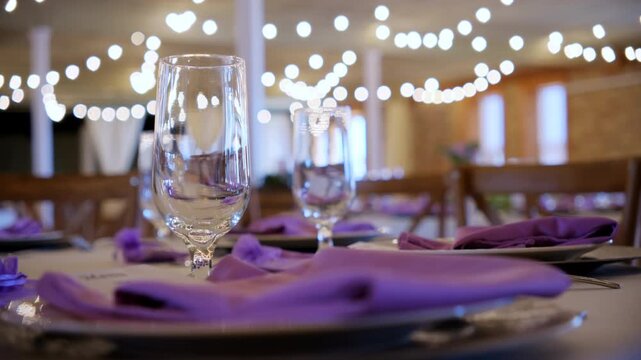 Served table with plates as a decoration at the party in restaurant. Purple elements of the Wedding, Birthday, Celebration Party. Move camera